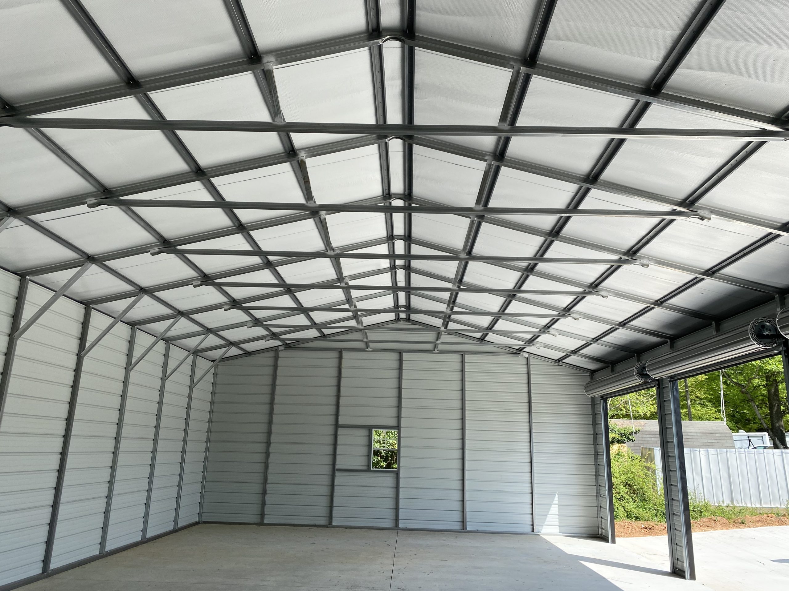 30x51x12 Vertical roof, Fully enclosed, 2 windows, one walk in door, 3 10x10 roll up doors on 51' side, roof insulated. Pic 2